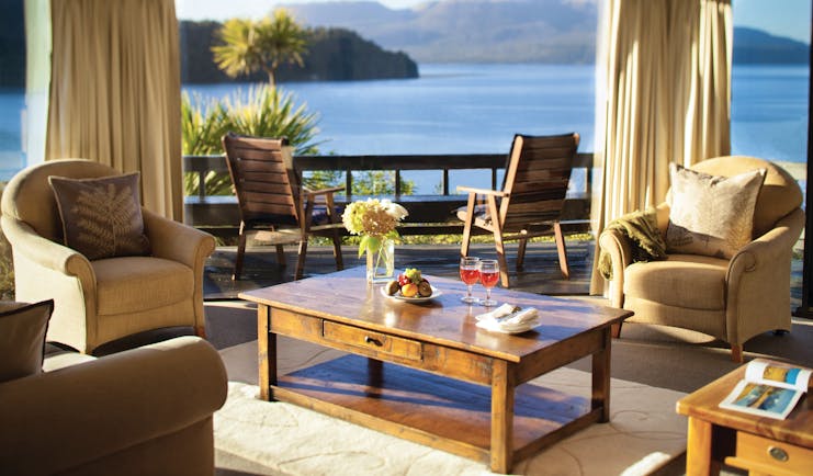 Solitaire Lodge suite, armchairs, coffee table, large windows with view over the sea