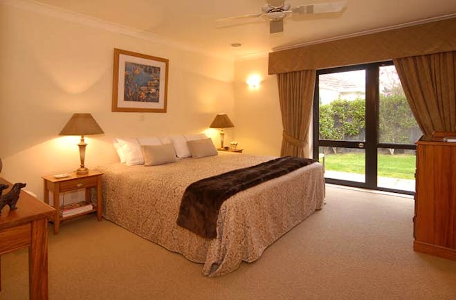 The Springs Central North Island Fairy Room bedroom with patio doors and garden view