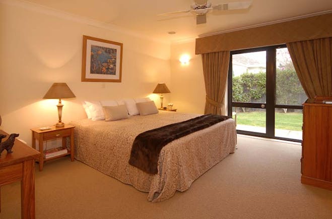The Springs Central North Island Fairy Room bedroom with patio doors and garden view