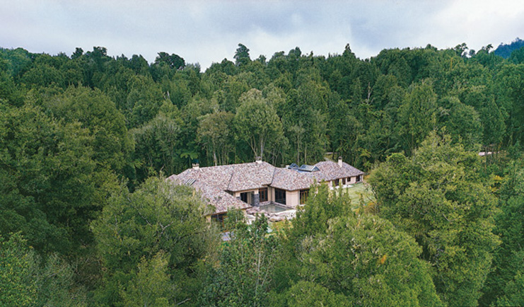 Treetops Lodge Central North Island aerial view of white lodge with grey roof surrounded by forest