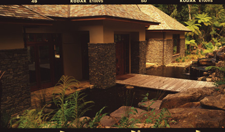 Treetops Lodge Central North Island bridge to access lodge building with stone columns