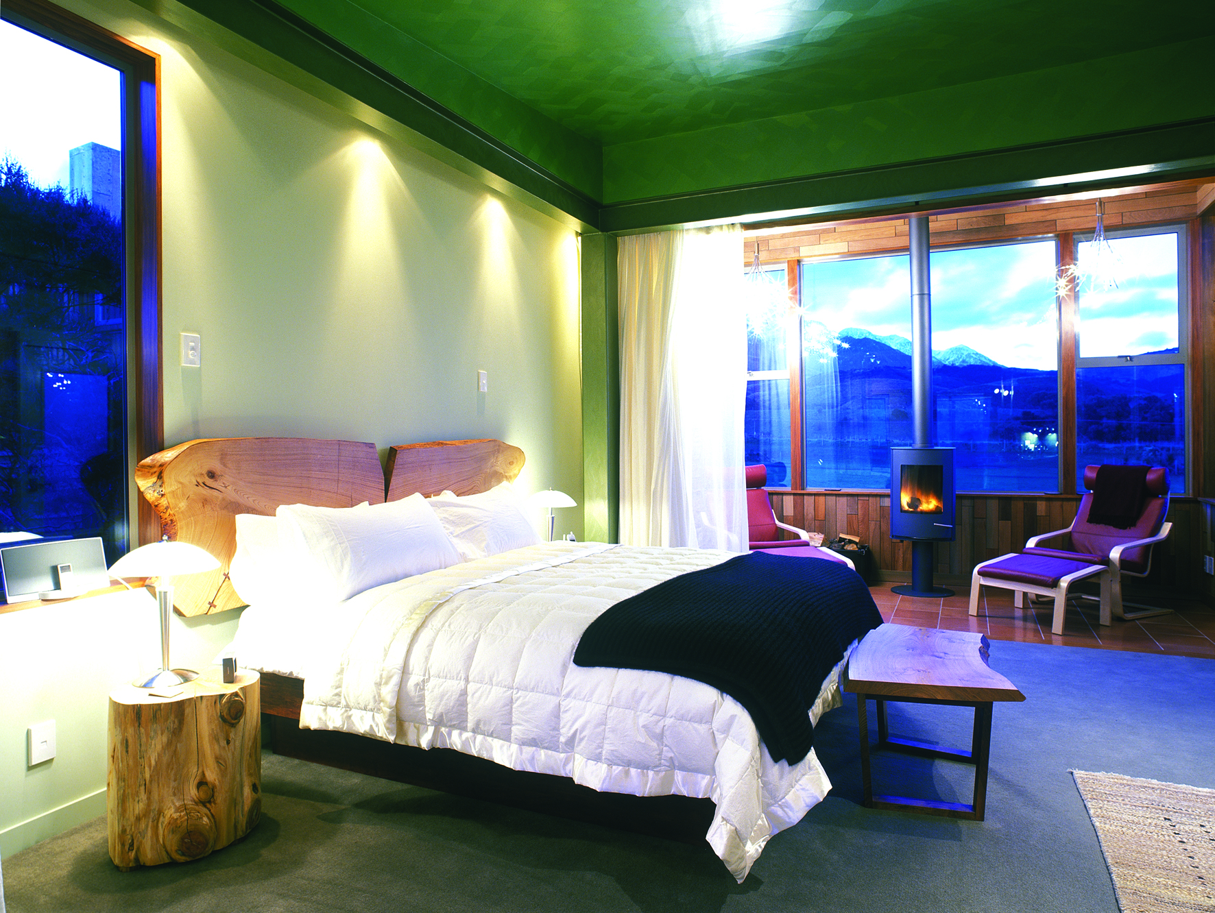 Hapuku Lodge Central South Island bedroom with fireplace and mountain view