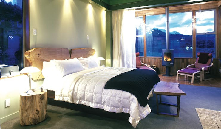 Hapuku Lodge Central South Island bedroom with fireplace and mountain view