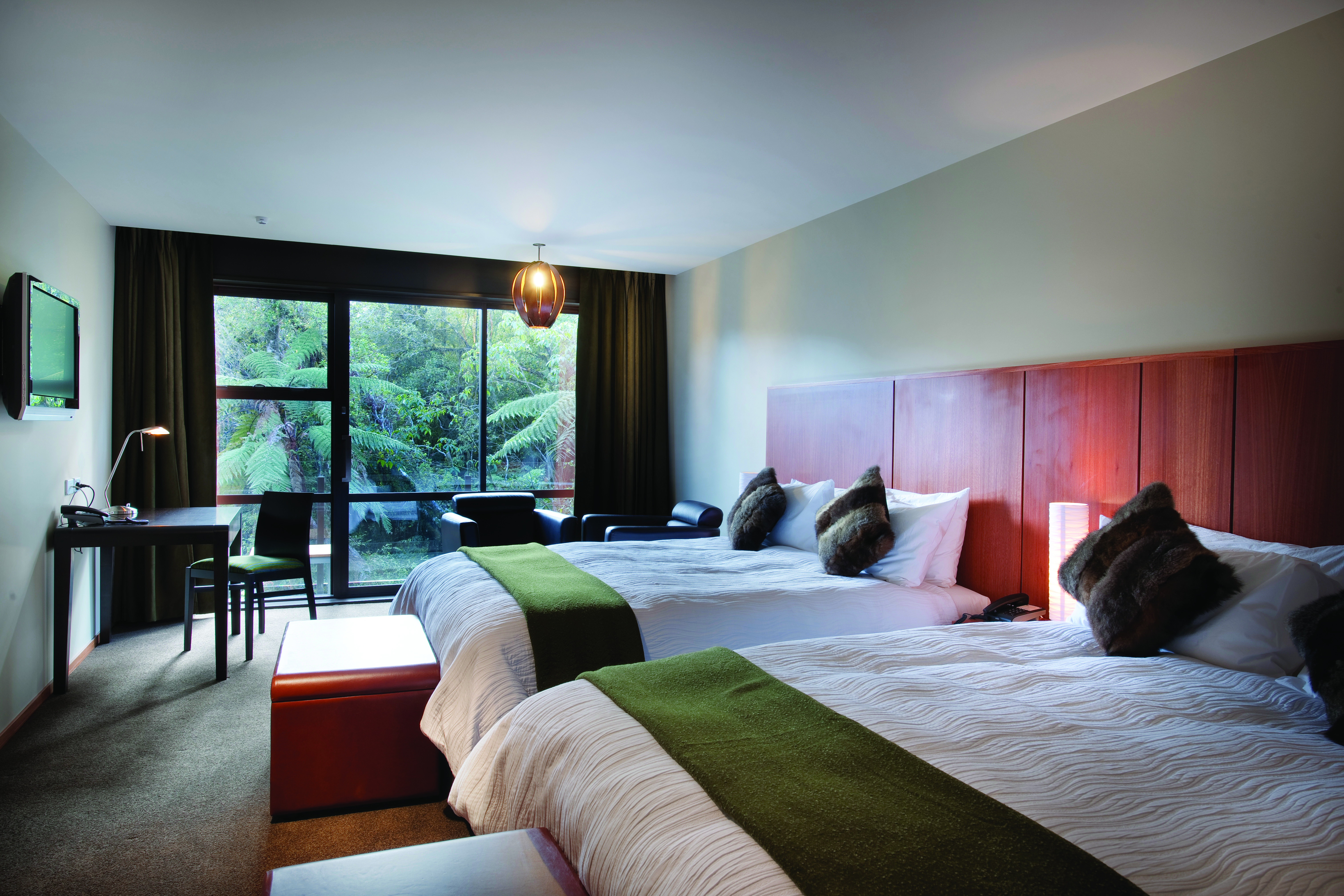 Te Waonui Forest Retreat Central South Island twin bedroom with desk and large windows