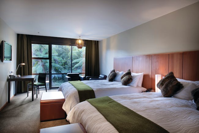 Te Waonui Forest Retreat Central South Island twin bedroom with desk and large windows