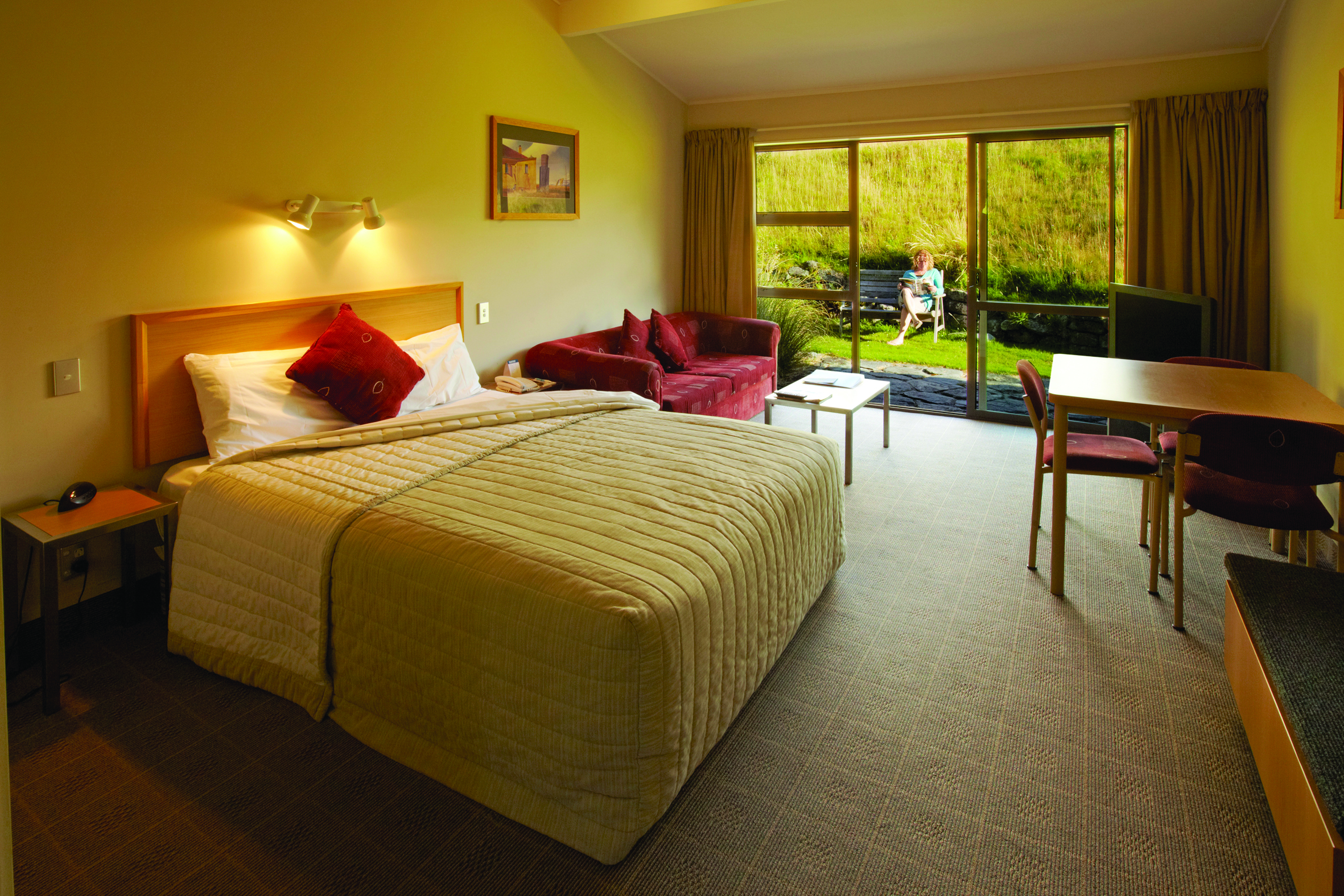 The Hermitage Hotel Central South Island bedroom with sofa and outdoor seating area
