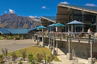 The Hermitage Hotel Central South Island cafe outdoor dining area with umbrellas and mountain view