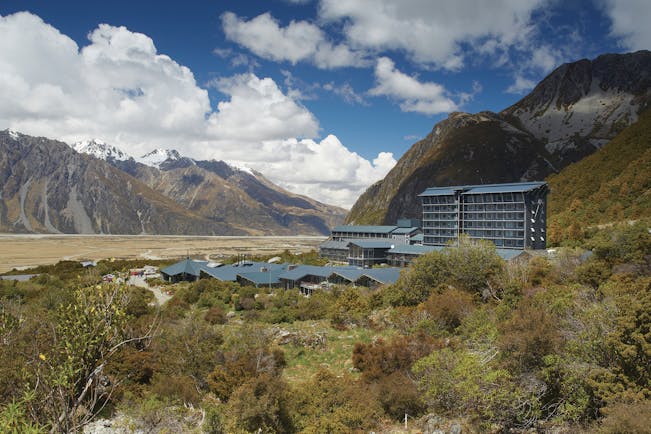 The Hermitage Hotel Central South Island exterior aerial view of buildings in a valley overlooked by mountains