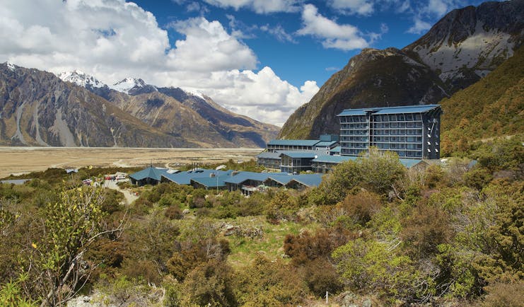 The Hermitage Hotel Central South Island exterior aerial view of buildings in a valley overlooked by mountains