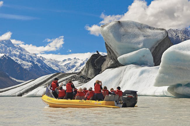 The Hermitage Hotel Central South Island glacier tour people in small boat looking at glacier