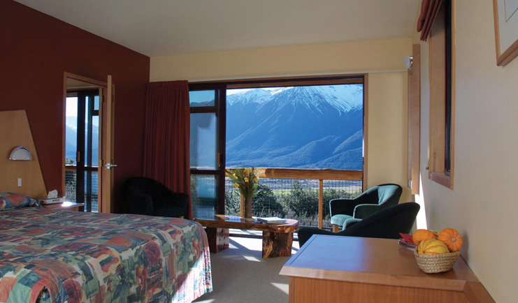 Wilderness Lodge at Nelsons Pass Central South Island bedroom with large windows overlooked by snow capped mountain