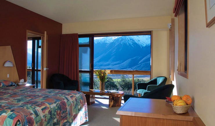 Wilderness Lodge at Nelsons Pass Central South Island bedroom with large windows overlooked by snow capped mountain