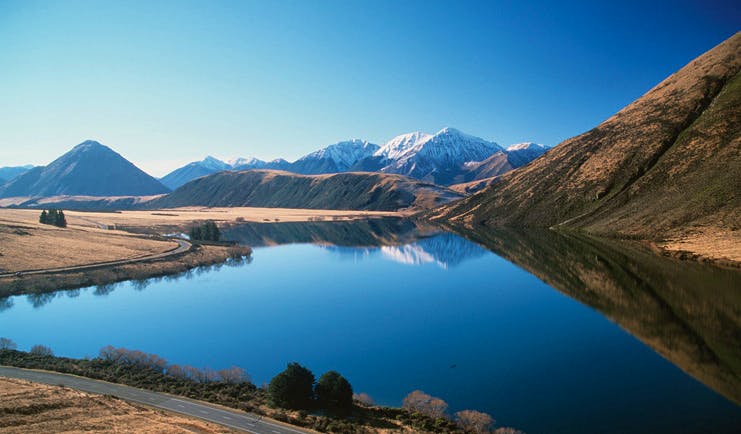 Wilderness Lodge at Nelsons Pass Central South Island lake surrounded by snow capped mountains