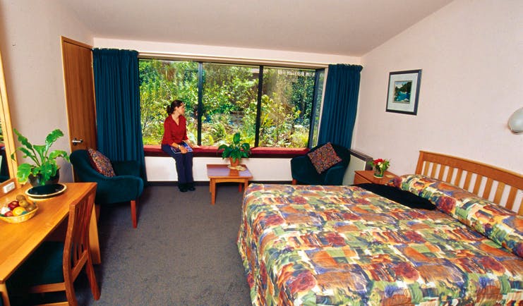 Wilderness Lodge at Nelsons Pass Central South Island room woman sat on windowsill in bedroom