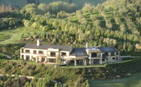 Beckenridge Lodge Hawkes Bay and Napier aerial view of large white building surrounded by trees