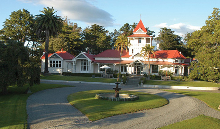 Greenhill Lodge Hawkes Lodge exterior white building with pink roof and lawns