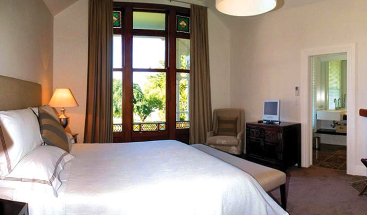 Greenhill Lodge Hawkes Lodge Mclean suite bedroom with large window and view to bathroom