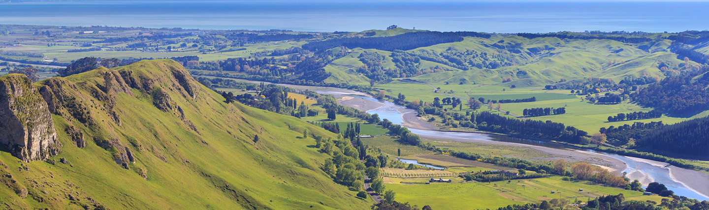 View of green mountain ridge with river in valley