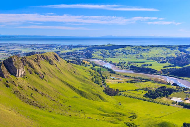 View from Te Mata Peak in Hawkes Bay, rolling countryside, verdant greenery, sea in background