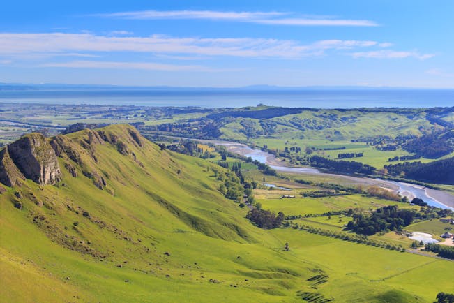 View from Te Mata Peak in Hawkes Bay, rolling countryside, verdant greenery, sea in background