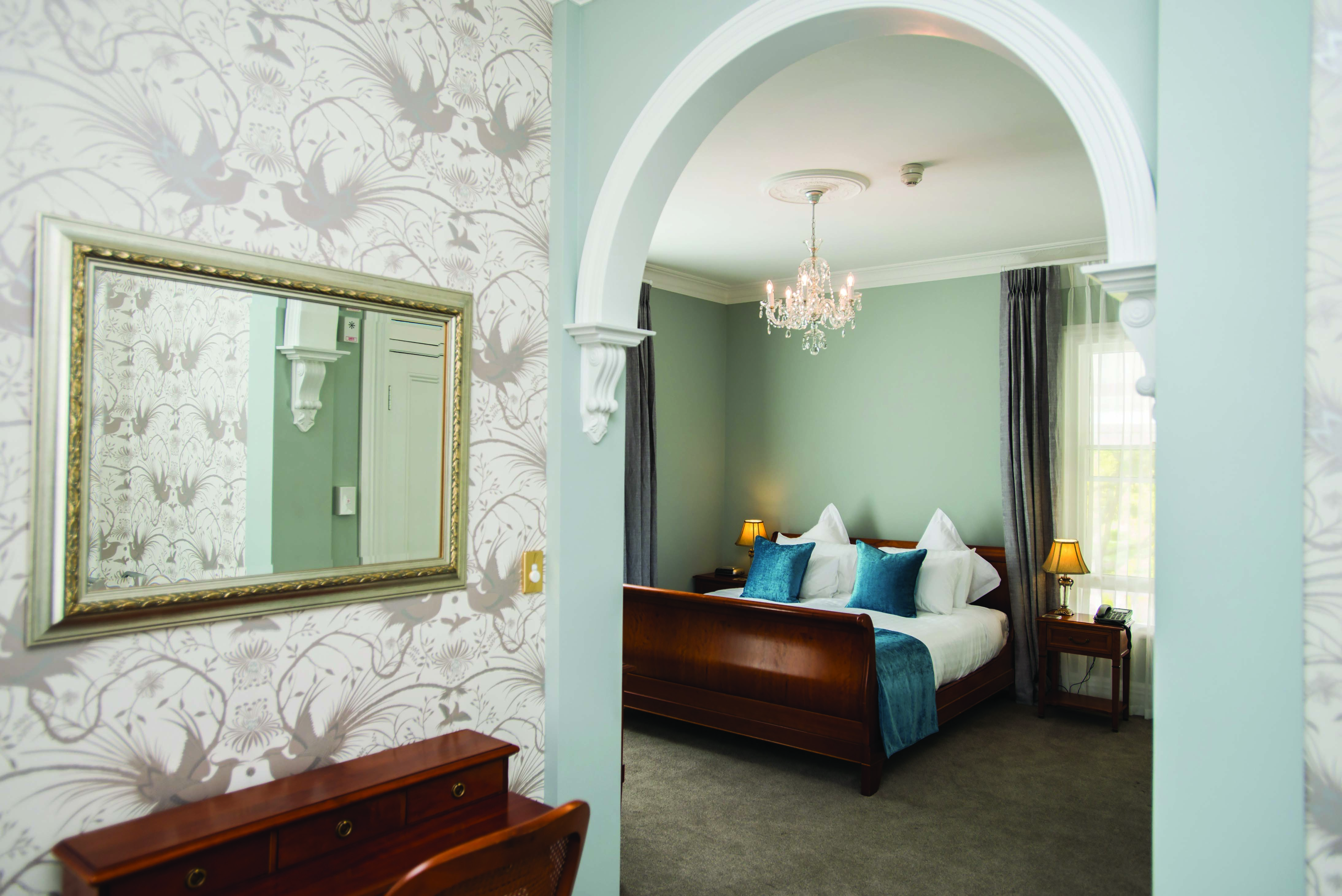 Mangapapa Hotel macron suite, bed, elegant architecture and decor, archway into bedroom