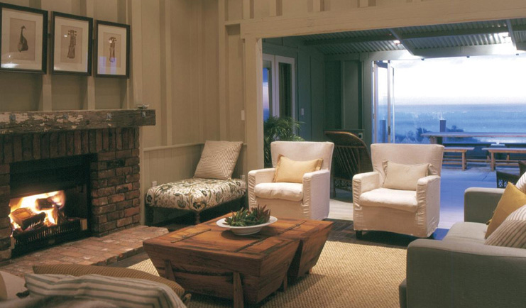 The Black Barn Hawkes Bay Beach House living room with fireplace and access to patio