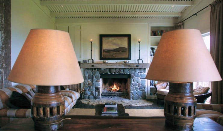 The Black Barn Hawkes Bay living room with sofas and stone fireplace