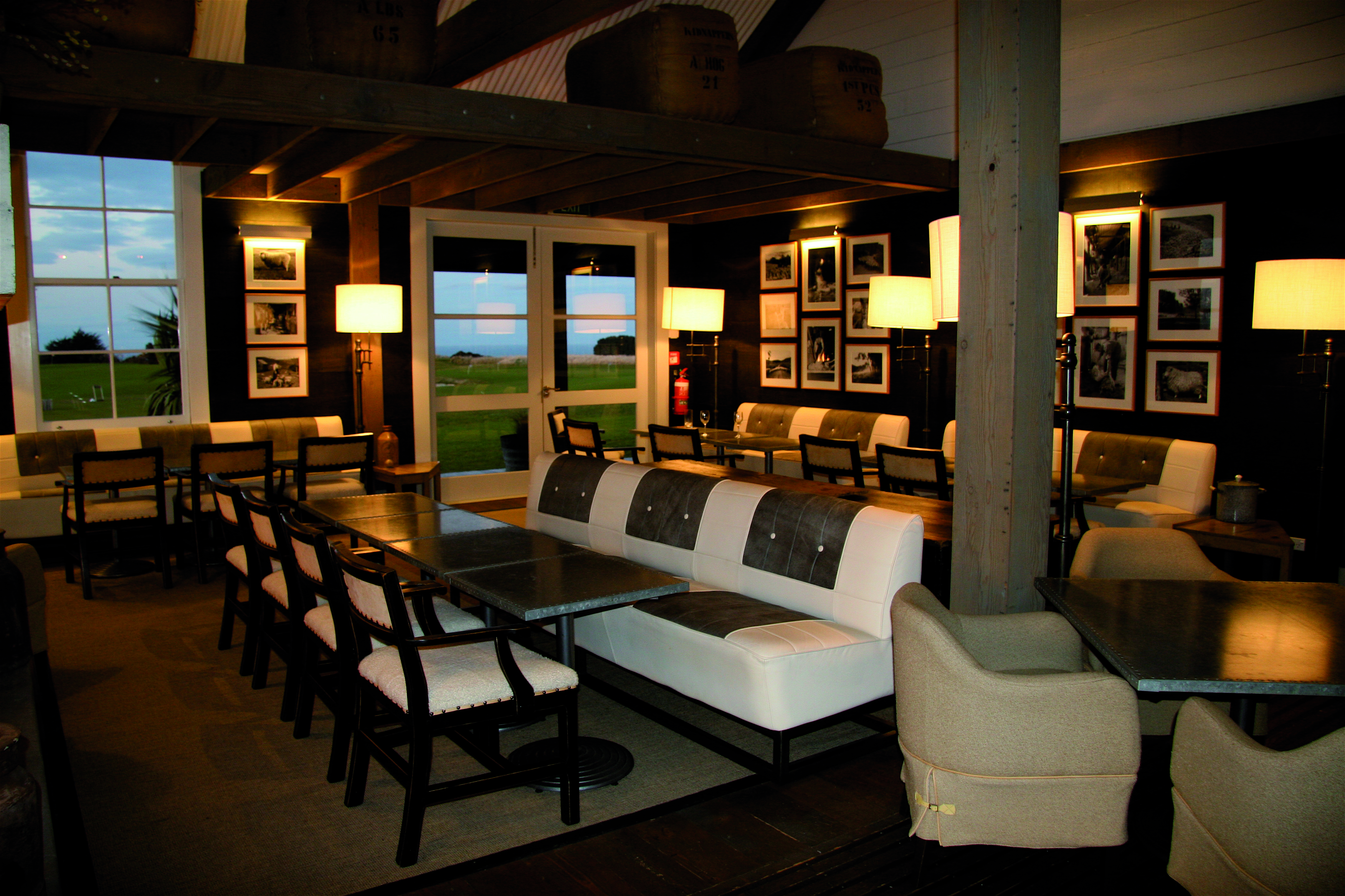 The Farm at Cape Kidnappers Hawkes Bay and Napier clubhouse lounge area with sofas tables with clifftop view