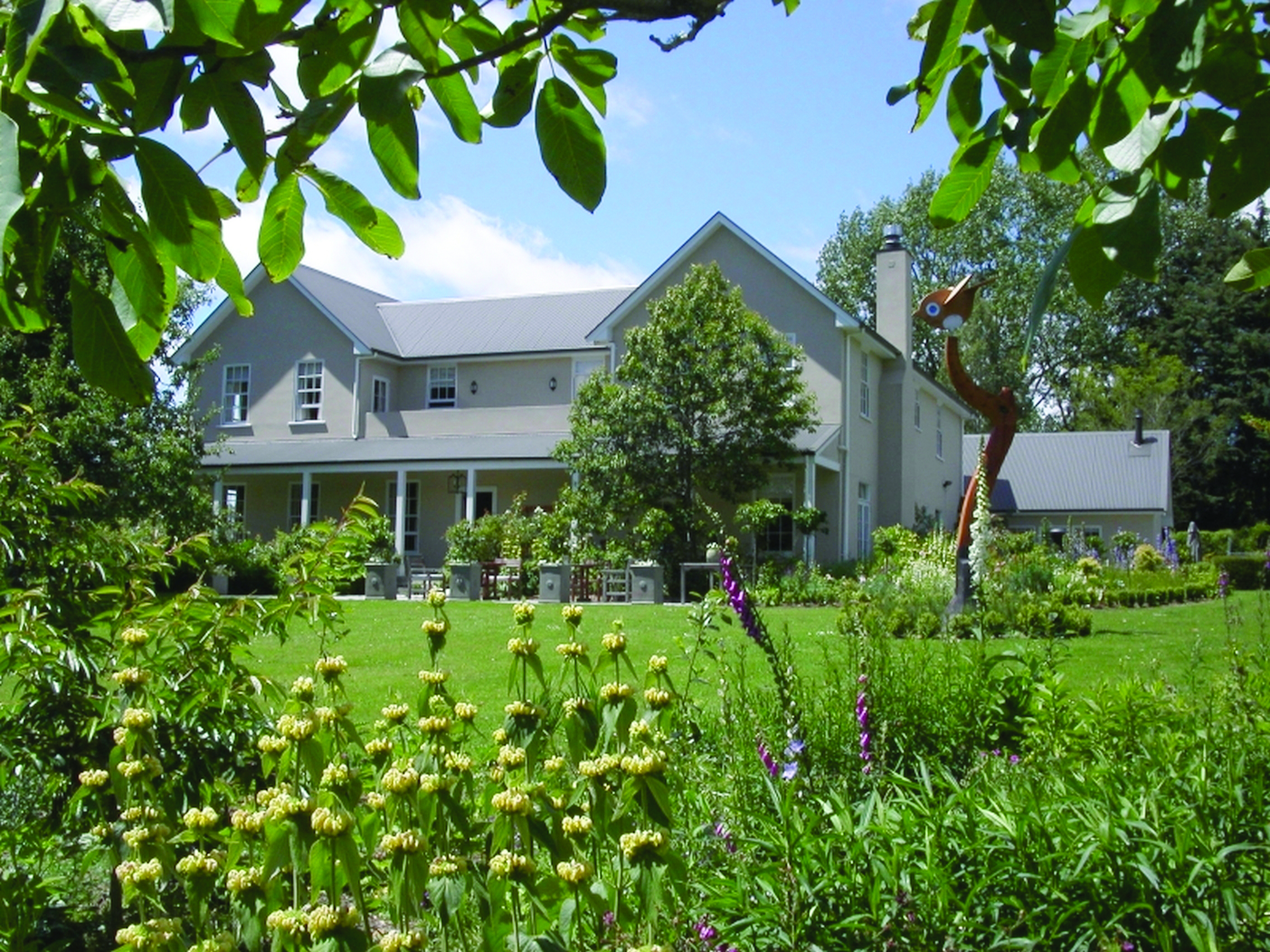 Edenhouse Luxury Lodge Nelson Abel and Tasman exterior large grey building with covered veranda and garden