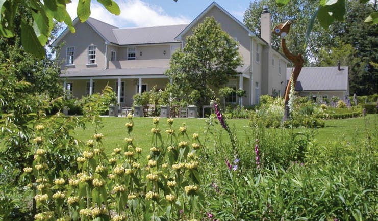 Edenhouse Luxury Lodge Nelson Abel and Tasman exterior large grey building with covered veranda and garden
