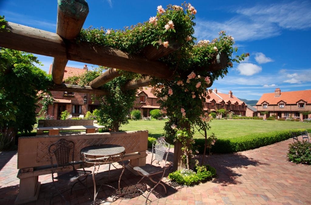 Grand Mercure Nelson Monaco Nelson Abel and Tasman garden complex of red brick buildings around lawn and garden area