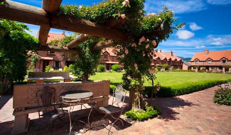 Grand Mercure Nelson Monaco Nelson Abel and Tasman garden complex of red brick buildings around lawn and garden area