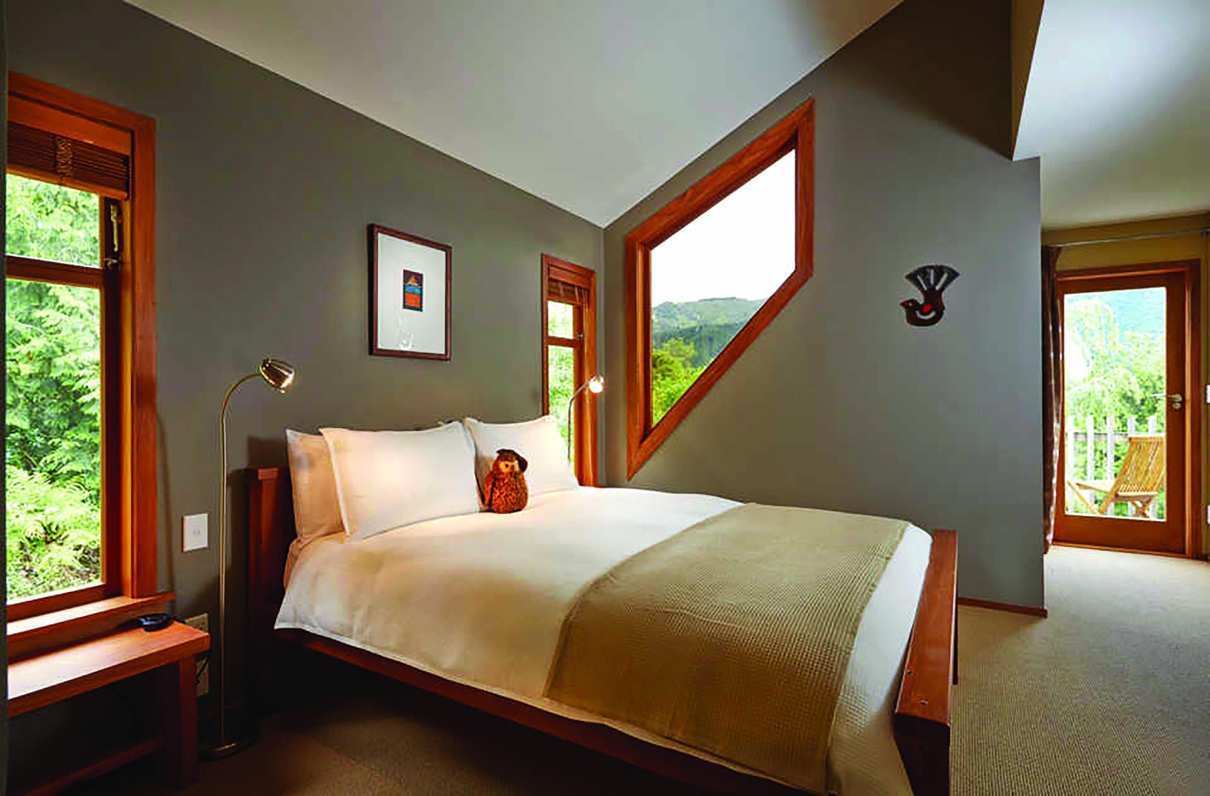 The Resurgence ecoLodge Nelson Abel and Tasman bedroom with angled window and patio door to balcony terrace