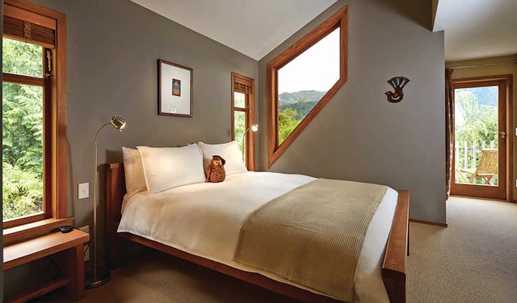 The Resurgence ecoLodge Nelson Abel and Tasman bedroom with angled window and patio door to balcony terrace