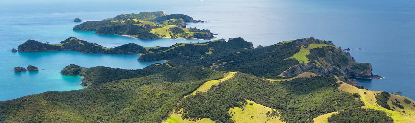 View from the air of green headland and islands with blue sea