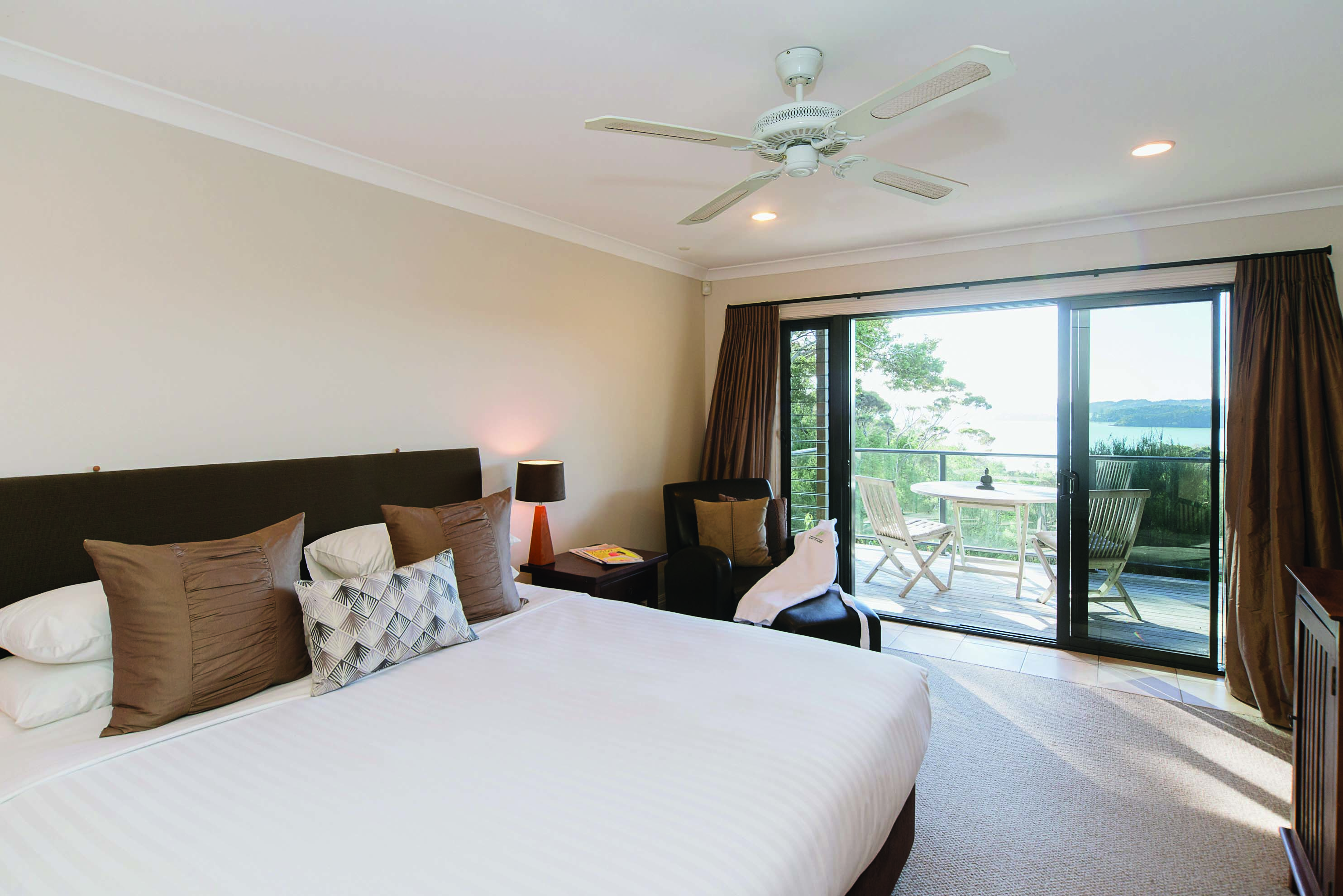 The Sanctuary at Bay of Islandas Northlands and Bay of Islands bedroom with patio doors to decked balcony