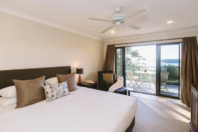 The Sanctuary at Bay of Islandas Northlands and Bay of Islands bedroom with patio doors to decked balcony