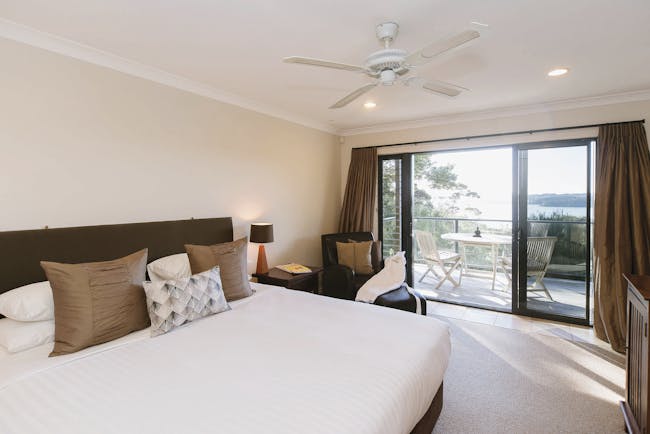 The Sanctuary at Bay of Islandas Northlands and Bay of Islands bedroom with patio doors to decked balcony