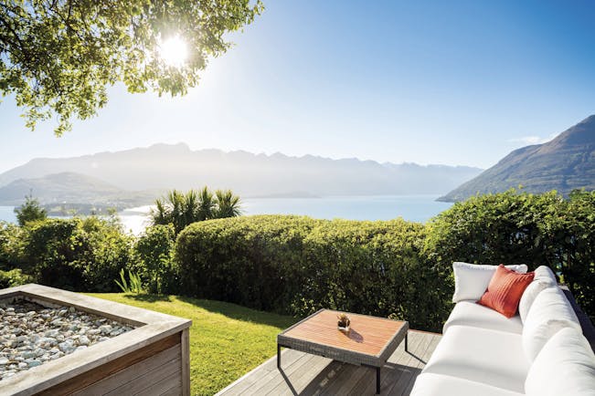 Azur Lodge Otago and Fiordland exterior view sofa in a garden overlooking mountains and water