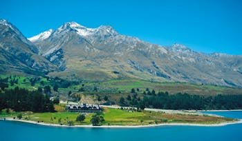 Blanket Bay Otago and Fiordland mountain lake lodge surrounded by lawns near lake and mountains