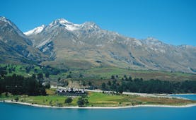 Blanket Bay Otago and Fiordland mountain lake lodge surrounded by lawns near lake and mountains