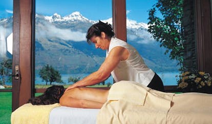 Blanket Bay Otago and Fiordland spa woman giving a massage with mountain view