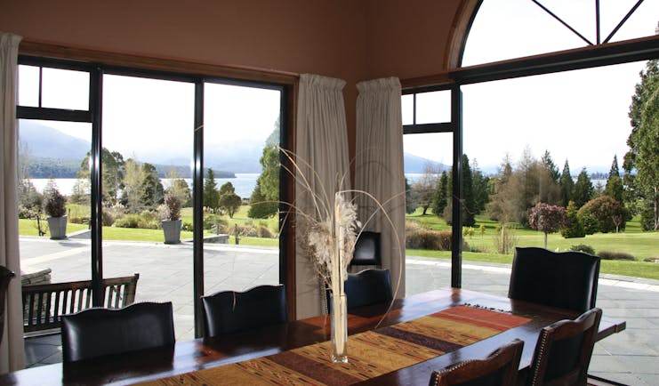 Dock Bay Lodge Otago and Fiordland dining room with large window and garden view