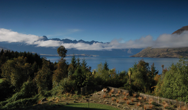 The Hidden Lodge Otago and Fiordland aerial forest view with lake and mountains
