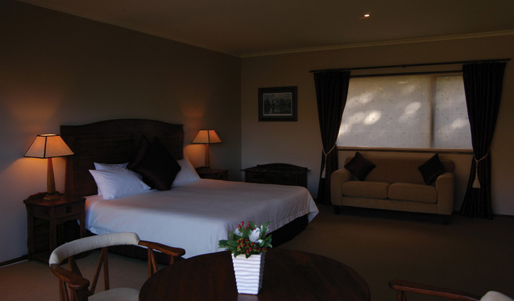 The Hidden Lodge Otago and Fiordland bedroom lounge with sofa and table