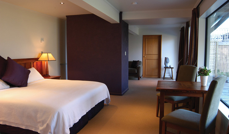 The Hidden Lodge Otago and Fiordland bedroom with sitting area and terrace