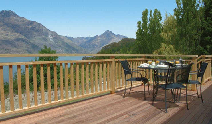 The Hidden Lodge Otago and Fiordland deck with table and chairs with mountain and lake view
