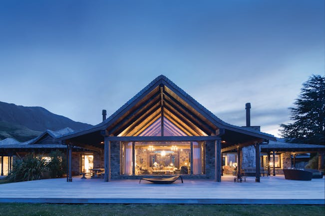 Mahu Whenua Otago and Fiordland exterior stone and wood lodge with floor to ceiling window