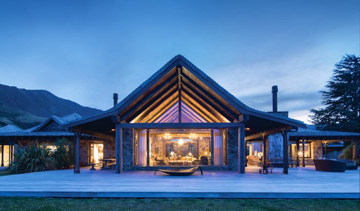 Mahu Whenua Otago and Fiordland exterior stone and wood lodge with floor to ceiling window