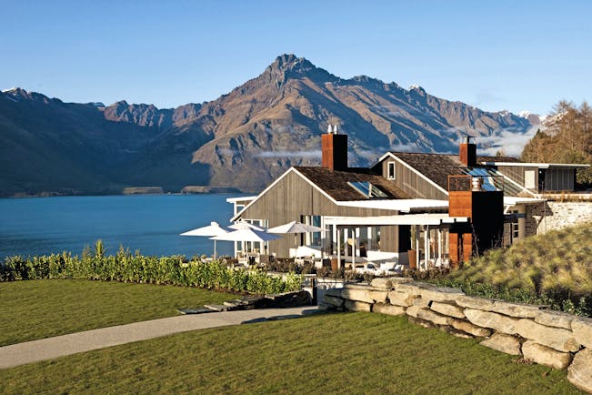 Matakauri Lodge Otago and Fiordland exterior wooden chalet with garden and mountain view